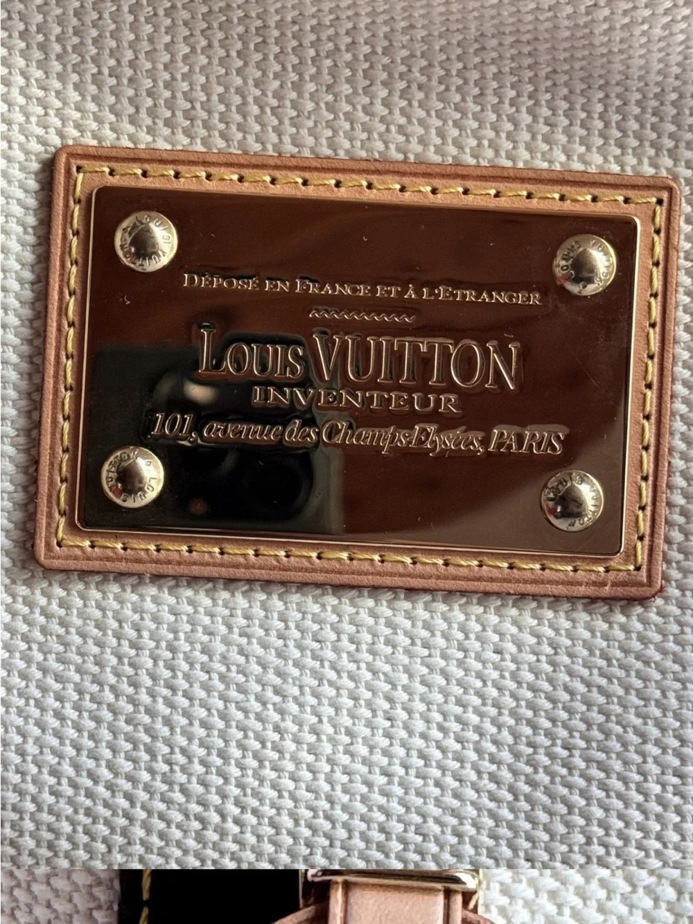 Authentic Louis Vuitton tote in brown leather trim and silver stud w/luggage tag